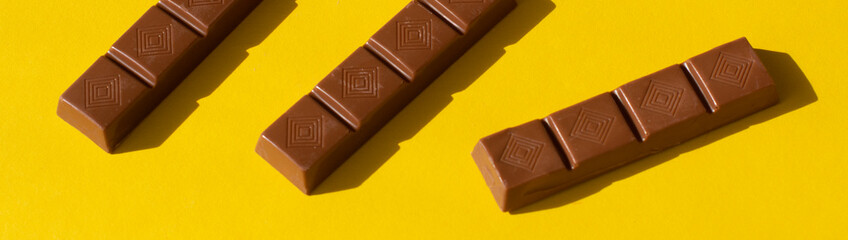small chocolate bars on a yellow background