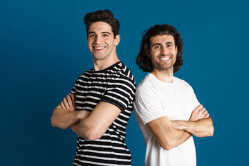 White brunette two men looking and smiling at camera