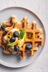 Breakfast with waffles with blueberries on a plates