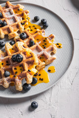 Breakfast with waffles with blueberries on a plates