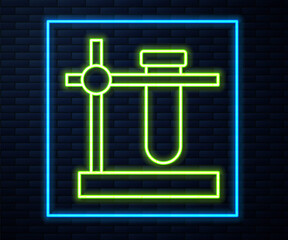 Glowing neon line Glass test tube flask on stand icon isolated on brick wall background. Laboratory equipment. Vector