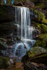 River and forrest rocks with visible movement and blur of the water