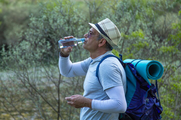 tired hiker or pilgrim stopping to rest and drink