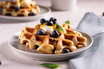Breakfast with waffles with blueberries on a plates