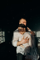 The guy hugs the girl. Heterosexual couple lifestyle moments at home. Conceptual photo about heterosexuality