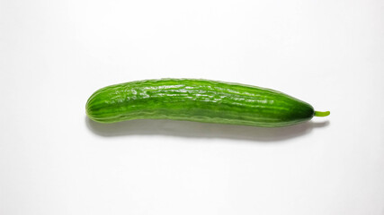 A whole fresh cucumber on a white background.