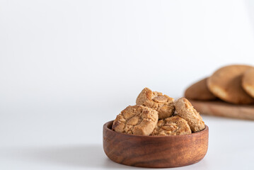 Butter cookies with almond tipical spanish in a wooden borl. White bachground. Horizontal.