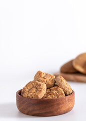 Butter cookies with almond tipical spanish in a wooden borl. White bachground. Vertical.