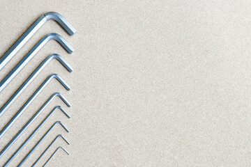 metal allen keys on a wooden background
