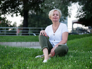 Old and stylish woman on a summer walk in beautiful city.