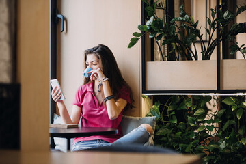 Slow living in city environment, Urban Slow life, mindfulness, mental health, enjoying the moment, work-life balance. Young Latina hispanic woman enjoying the sun and drinking coffee near cafe window.