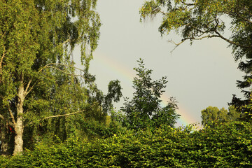 Obraz na płótnie Canvas Beautiful rainbow slicing the sky after a storm in the Highlands