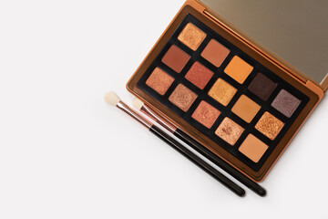 Multicolored eyeshadow palette with makeup brushes
