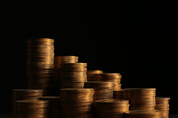 A large variety of coins on a black background. Stack of coins