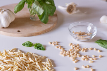 Basil, pine cones, garlic and Trofie pasta to make a traditional Italian Pesto dish