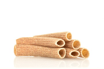 Dark brown, uncooked, organic rye pasta, close-up isolated on white.