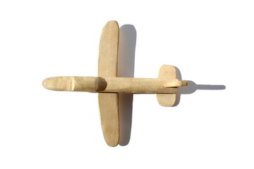 Homemade wooden plane stands on a white background