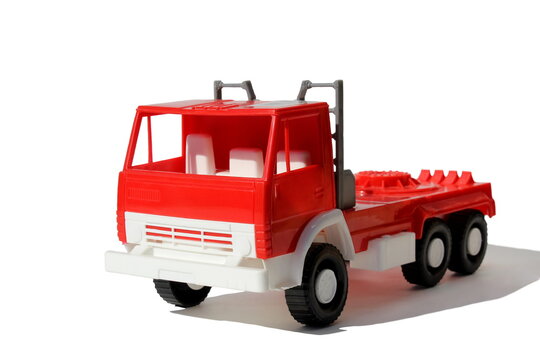 Red large cargo toy car stands on a white background