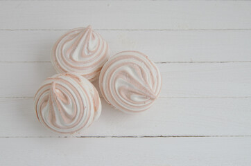 Coffee marshmallow on a white wooden background with yellow bokke. Light dessert for the holiday