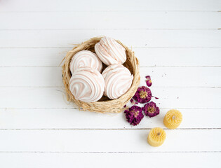 Coffee marshmallow on a white wooden background with yellow bokke. Light dessert for the holiday