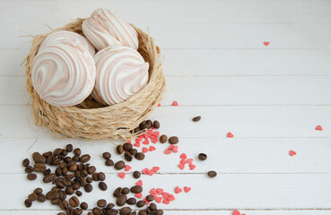 Coffee marshmallow on a white wooden background with yellow bokke and coffee beans. Light dessert for the holiday