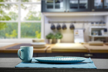 Table background with plate and mug and kitchen interior 