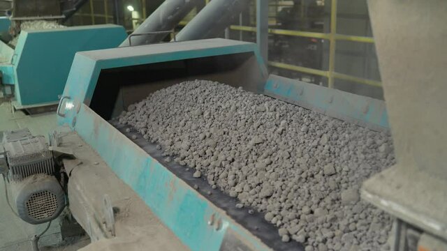 Close-up of bulk materials in a factory. Processing of raw additives in bulk at the plant. Crushed stone for addition to cement. Cement additives at the plant.