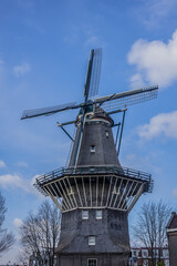 Fototapeta na wymiar De Gooyer Windmill - Amsterdam most iconic mill. De Gooyer Windmill - was built in 1725 - the tallest wooden mill in the Netherlands. Amsterdam, Netherlands.