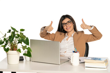 Happy businesswoman at her desk, isolated on white background.