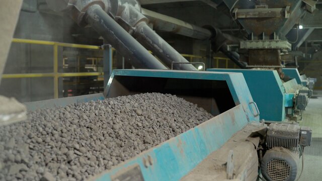 Close-up of bulk materials in a factory. Processing of raw additives in bulk at the plant. Crushed stone for addition to cement. Cement additives at the plant.
