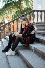 Sustainable living, use of natural and renewable resources, Reduce consumption, Sustainable Lifestyle. Young brunette woman in rustic dress walking along village road with mesh bag and Homemade Bread