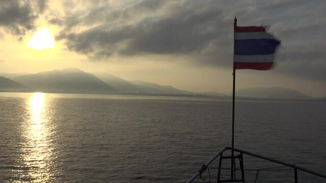 sailing in the sunrise to the thailand coast.