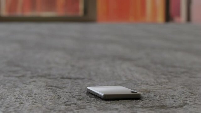 3D Rendering of a Smartphone hitting a stone floor and not being damaged
