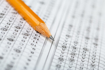 testing in exercise and exam paper. computer sheet with pencil in school test room, education concept. filling in answers in pencil