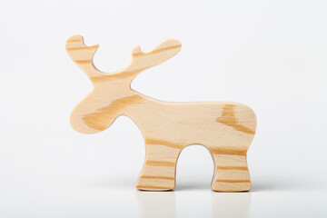 A figurine of an elk or a deer carved from solid pine with a hand jigsaw. On a white background