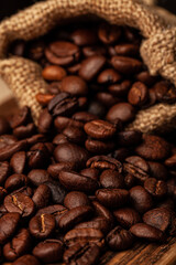 Roasted coffee beans on the old dark wooden background for wallpaper or decor