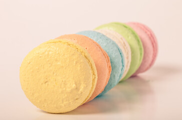 Colorful cake macaroons on a light background. Toned