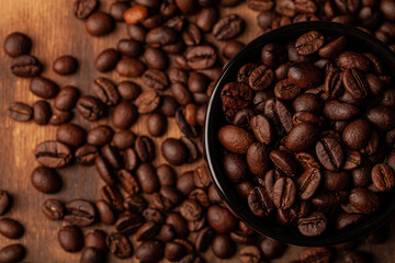 Roasted coffee beans on the old dark wooden background for wallpaper or decor