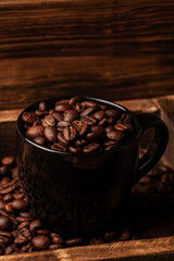 Roasted coffee beans on the old dark wooden background for wallpaper or decor
