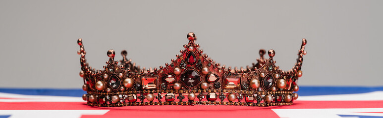 luxury royal crown on british flag isolated on grey, banner