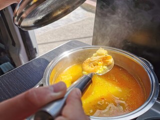 Family vacation, RV holiday trip, camping. Happy smiling woman cooking in camper. Motorhome interior