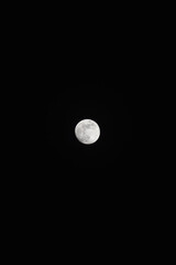 Brightly shining moon in a cloudless night sky