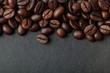 Roasted coffee beans on the black background for wallpaper or decor