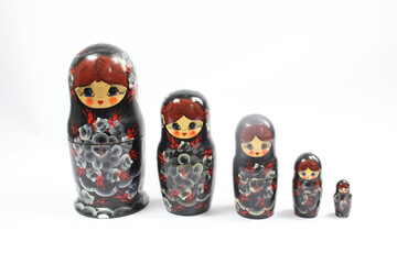 Collection of Wooden Nesting Stacking Dolls on White Background