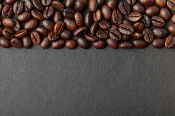 Roasted coffee beans on the black background for wallpaper or decor