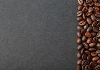 Roasted coffee beans on the black background for wallpaper or decor
