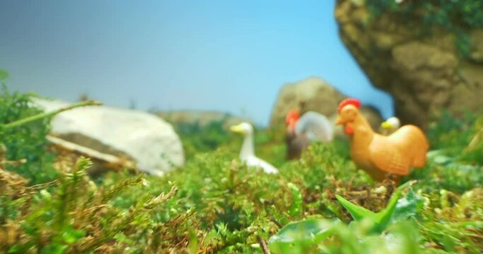 detailed extreme close-up of farm animal model in moss and grass.