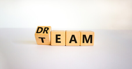 Dream team symbol. Turned the cube and changed the word 'dream' to 'team'. Beautiful white table, white background. Business and dream team concept, copy space.