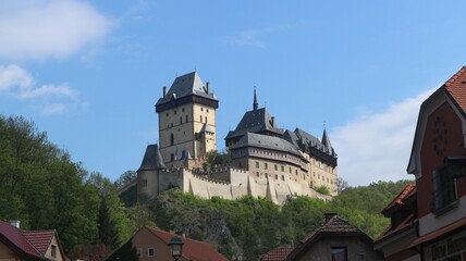 Fototapeta na wymiar A view to the medieval castle Karlstejn with blue sky above at Czech republic