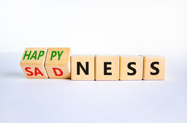 Happyness or sadness symbol. Turned cubes and changed the word 'sadness' to 'happyness'. Beautiful white background. Business, psychological and happyness or sadness concept. Copy space.